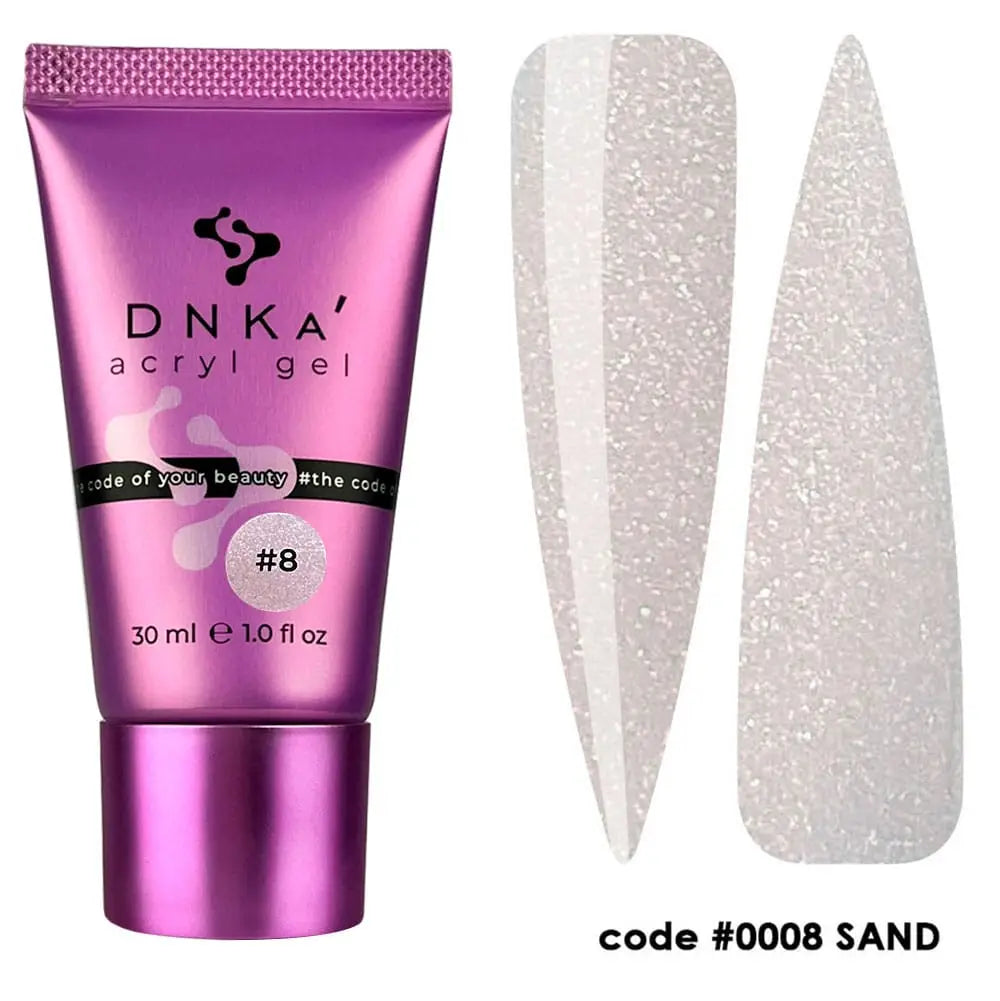 A tube of DNKa' Acryl Gel in color Sand (beige with shimmer), accompanied by a pair of nail art stickers with a glittery finish.