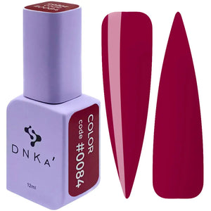 A bottle of DNKa' Gel Polish in color #0084, which is a deep red or maroon color, alongside a sample nail color swatch.