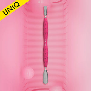 A manicure pusher tool with a silicone handle in a pink color, with a stainless steel working part, displayed on a pink background.