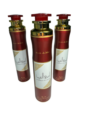 Three air freshener bottles with red and gold caps on a white background