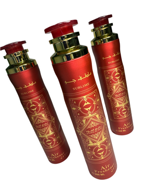 Three red and gold air freshener bottles with intricate designs on a white background