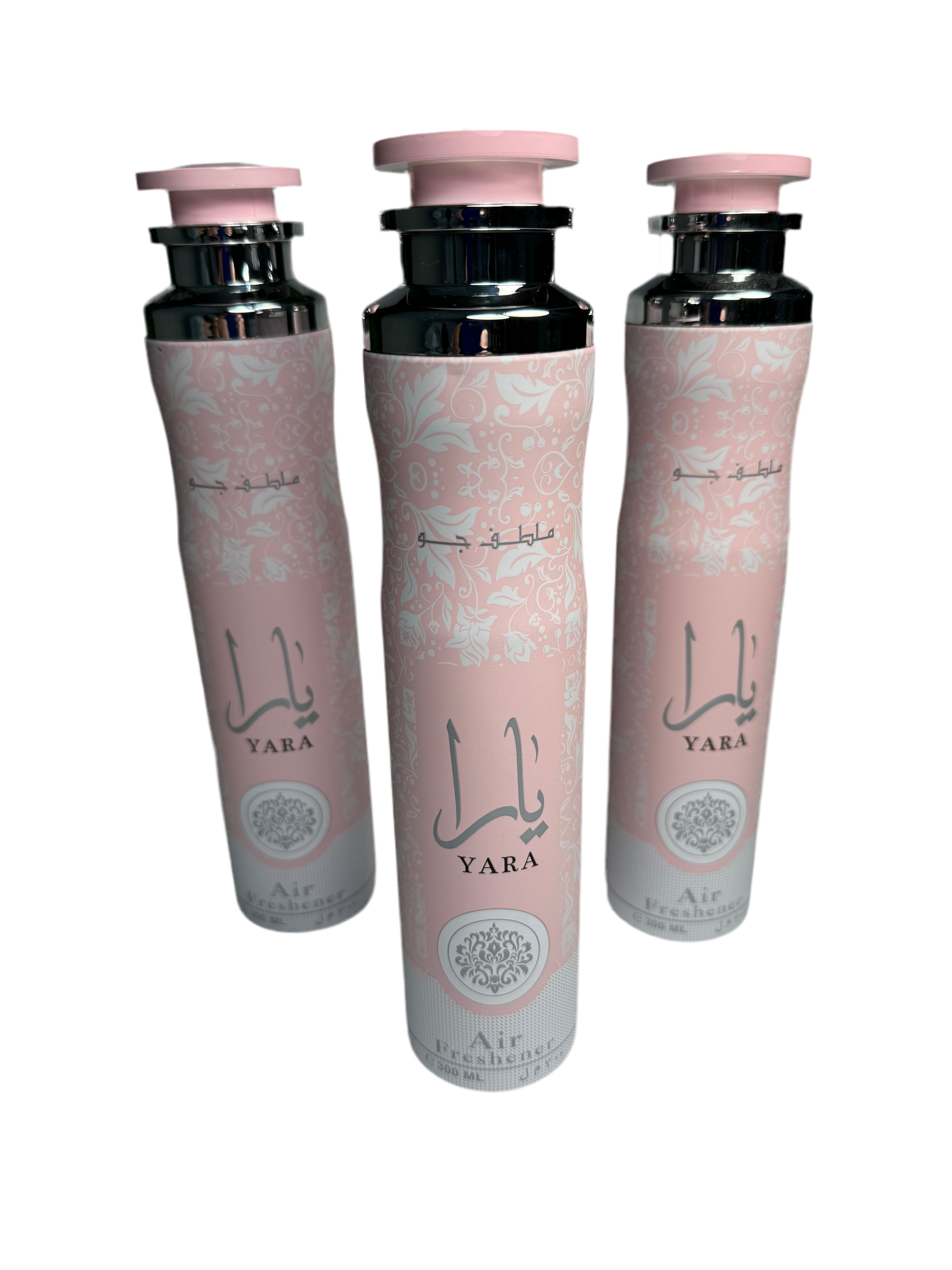 Three bottles of Yara perfume with pink caps on a white background
