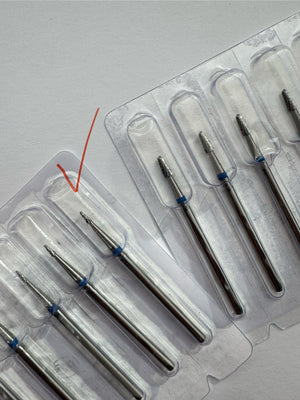 A professional carbide nail drill bit with a blue ring at the base, cone-shaped with fine teeth for nail and pedicure tasks.