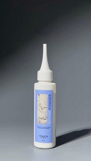 A white squeeze bottle of TOUCH Before Powder makeup with a light blue label, set against a dark gray gradient background.