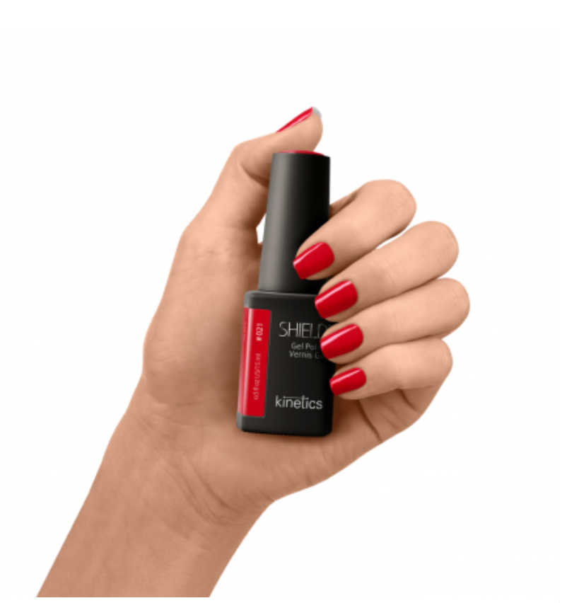 A bottle of SHIELD brand gel polish in a color named Kinetics #021 Victory, with a red cap and a label that includes the product name and brand logo.