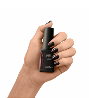 A bottle of SHIELD professional gel polish in a maroon color with a label reading 'Kinetics #516 My glower'. The bottle has a black cap and a maroon-colored label background.