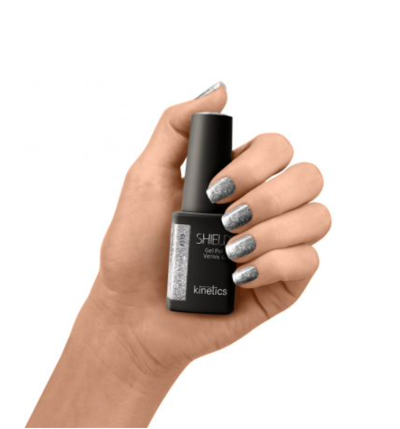 A bottle of SHIELD Gel Polish in the color Kinetics #519 Influence spices, with a matte black finish and silver flakes visible in the polish.