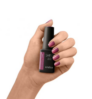 A bottle of Kinetics Shield Gel Polish in a pinkish purple shimmer shade with a black cap and label. #599 Magnetic splash cat eye colour
