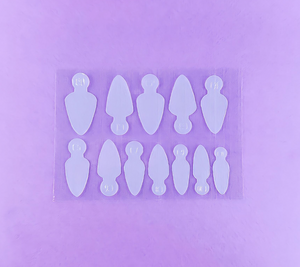 A set of 36 silicone nail molds of various sizes displayed on a purple background, intended for modeling French manicures.