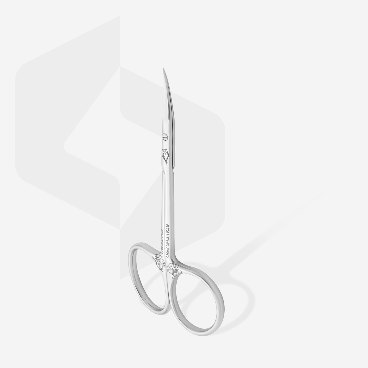 Professional cuticle scissors with curved handles and narrow tips, displayed alongside a straight edge, on a purple background with a magnolia leaf motif.