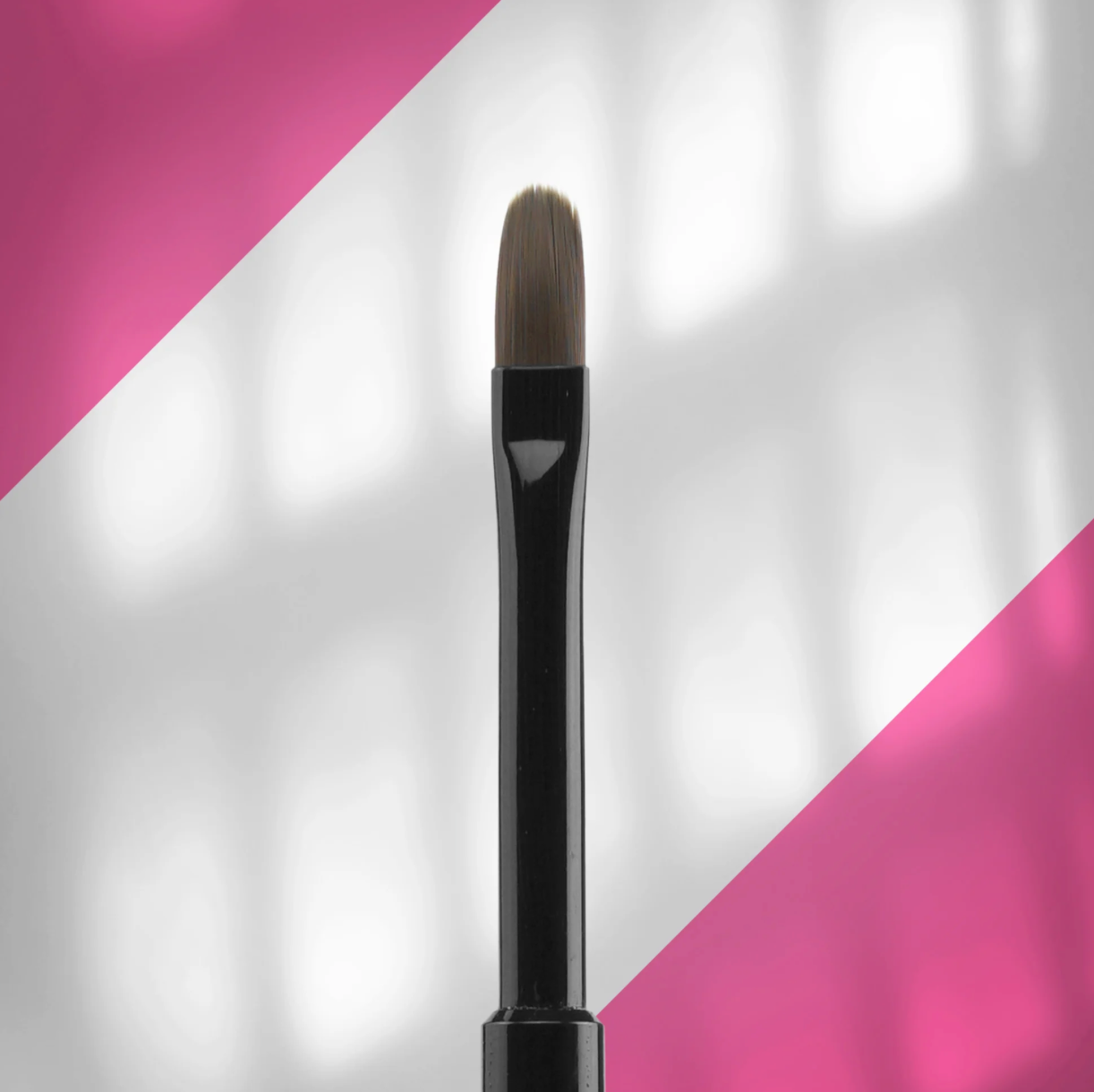 A black nail polish brush with an oval-shaped head and synthetic bristles. width: 6 mm. length: 11 mm.