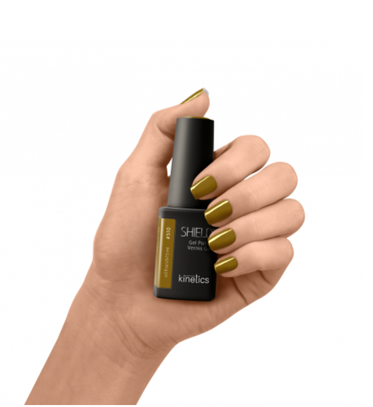Hand holding a black nail polish bottle with gold accents on a white background