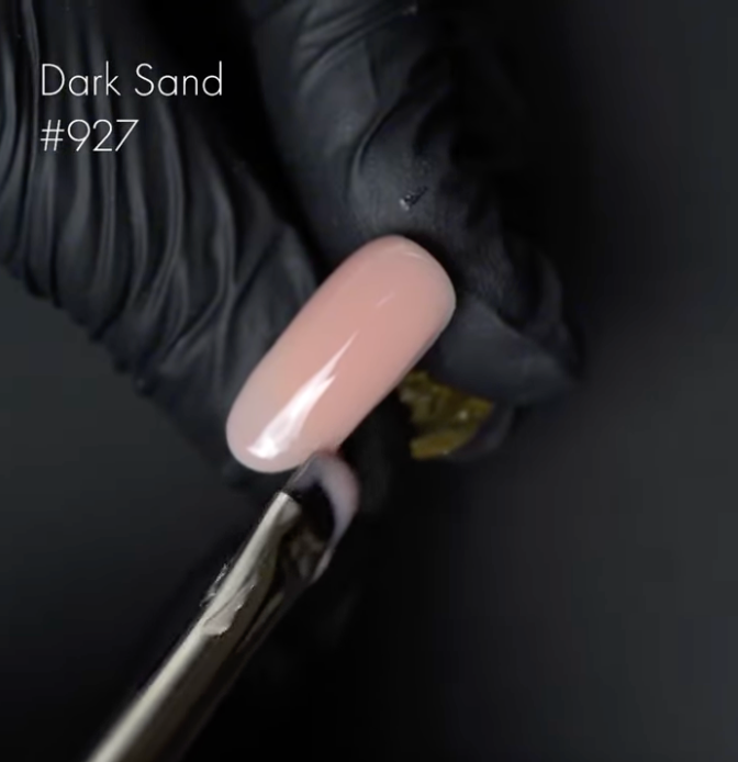 Nail polish swatch on a black background with 'Dark Sand #927' text