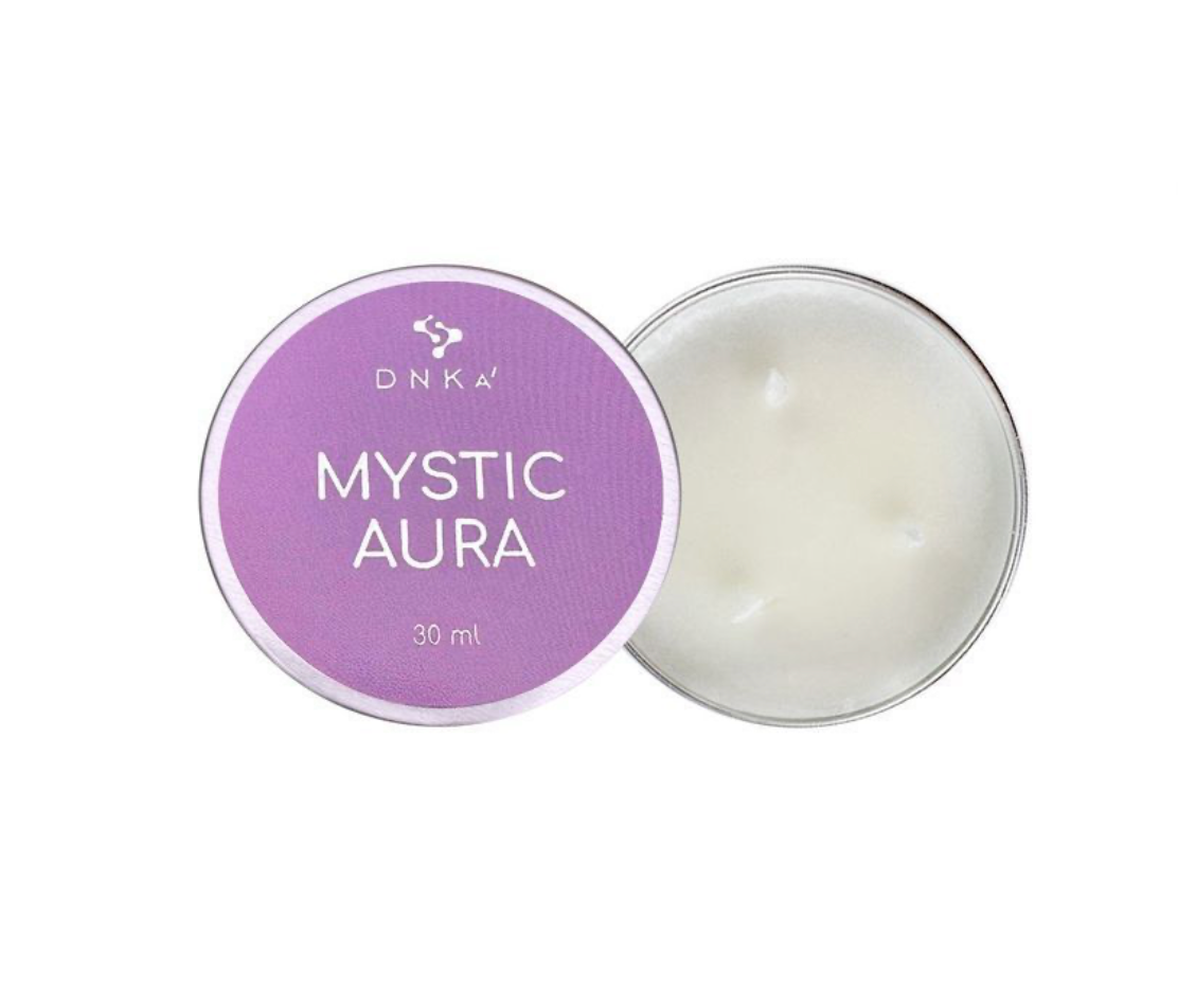 DNKA Mystic Aura candle in a tin with purple lid on a white background