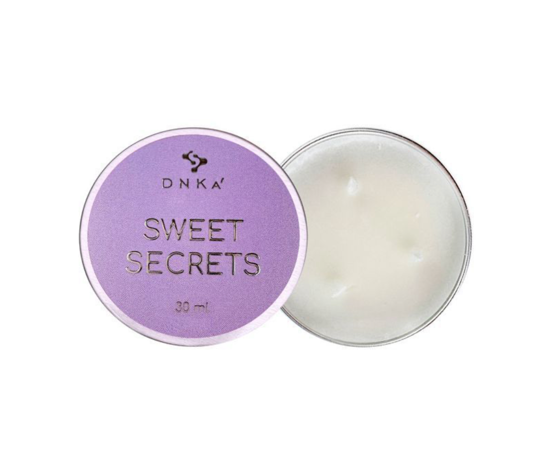 DNKA Sweet Secrets candle with purple lid on a white background