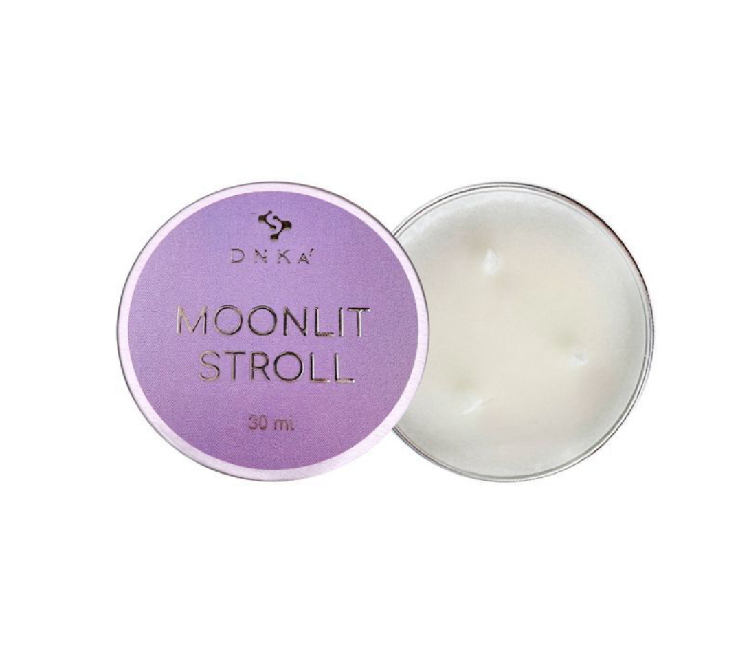 Cosmetic container labeled 'Moonlit Stroll' with a purple lid on a white background