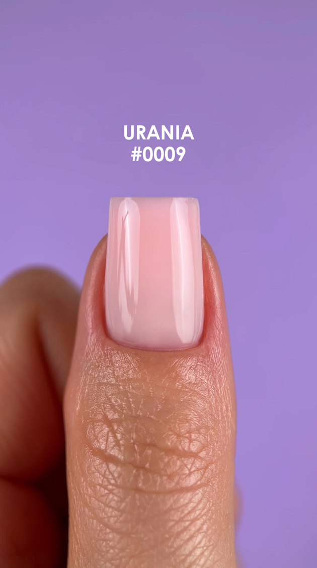 Nail with pink polish on a purple background, labeled 'URANIA #0009'.