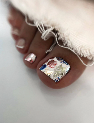 Close-up of toes with decorative nail art on a white background
