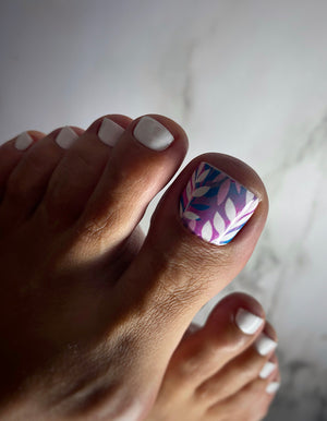Close-up of a foot with a decorated toenail on a neutral background