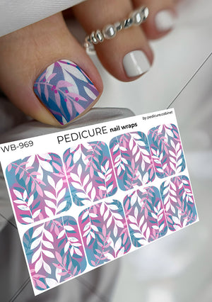 Nail wrap sheet with pink and blue leaf design next to a pedicured toe