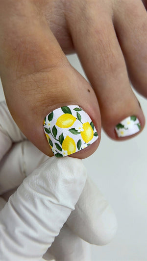 Nails pedicure wraps with lemon design on a white background