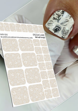 Nail art foil sheet with decorative patterns and a close-up of a pedicure nail wrap wearing the foil.