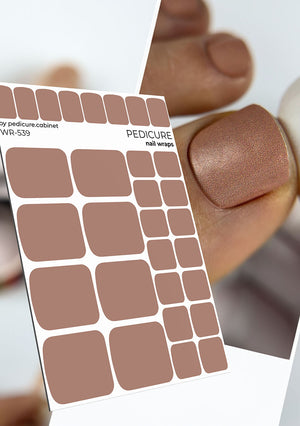 Sheet of pedicure nail wraps with a close-up of a nail wearing a brown color.