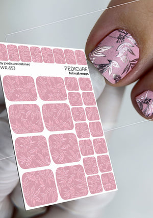 Sheet of pink foil nail wraps with a floral design on nails.