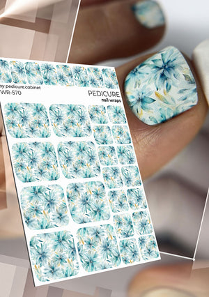 Sheet of floral nail wraps with a close-up of applied nail wrap on a thumb.