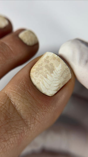 Pedicure nail wrap nude color with leaves on white background