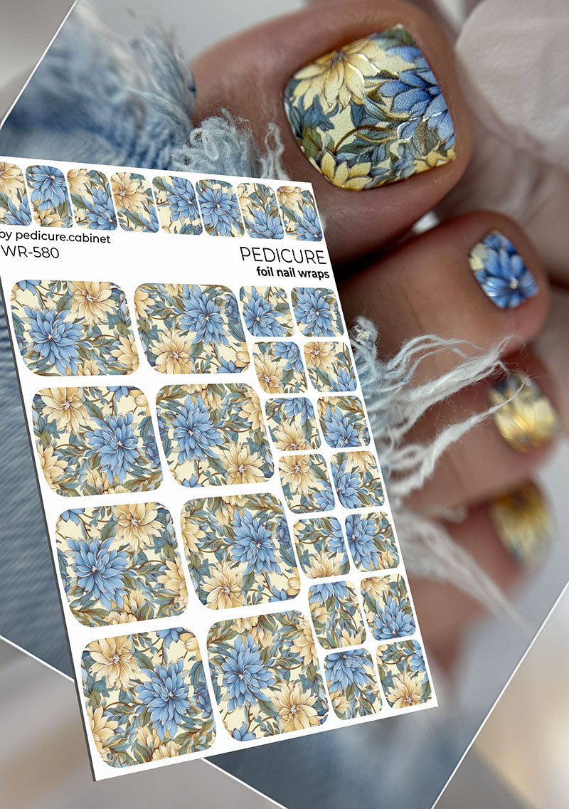 Foil nail wraps with floral design on a sheet and applied to nails.