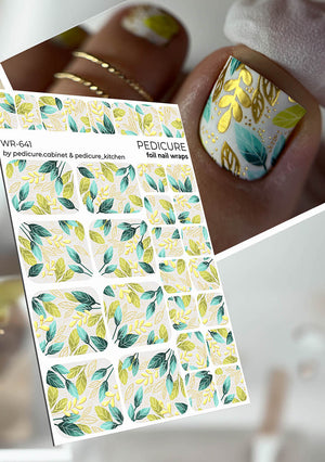 Foil pedicure nail wrap with leaf pattern held by a hand