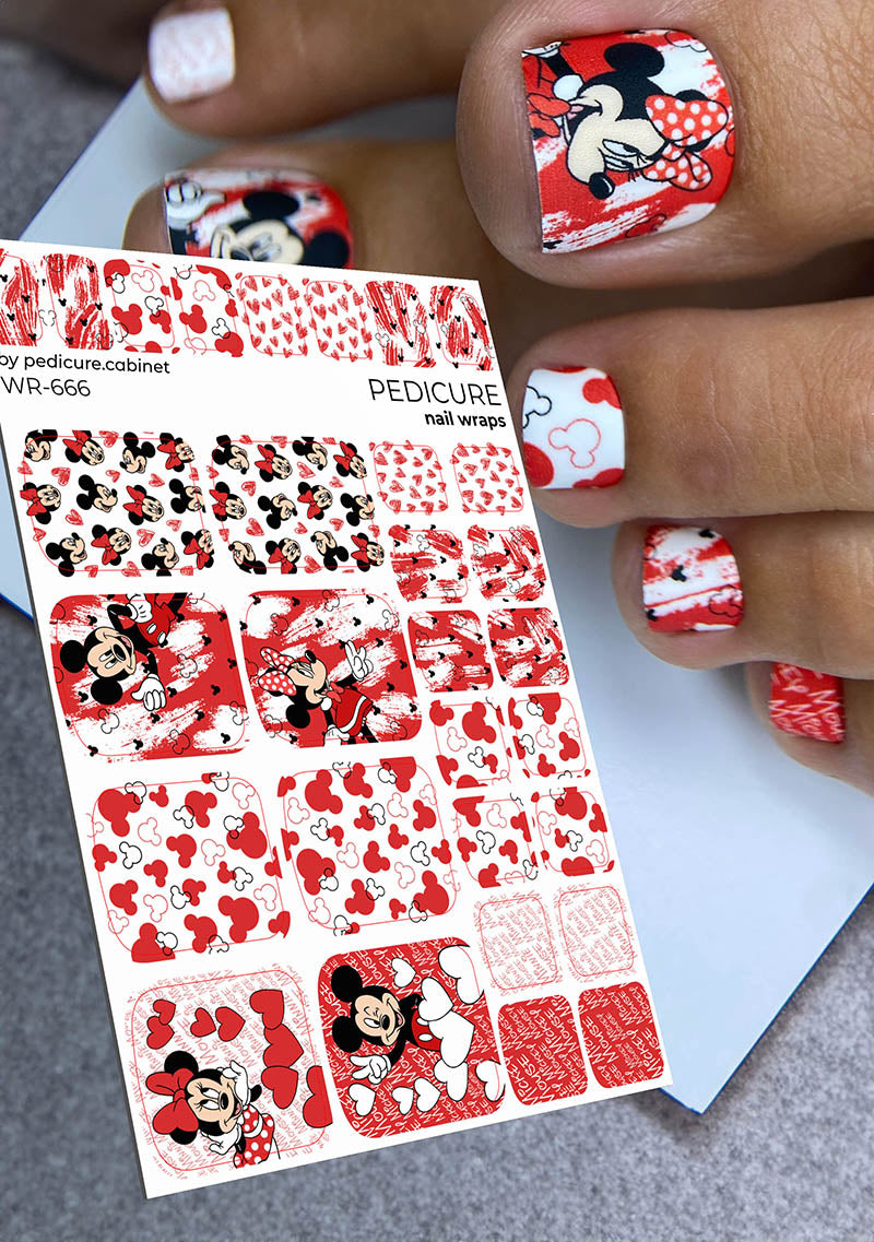 Nail wraps with Mickey Mouse design held by a hand with matching nail art.