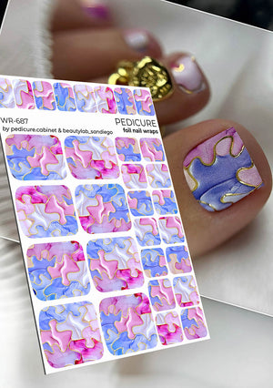Foil pedicure nail wraps with pink and blue design on a white background