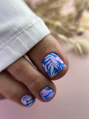 Nail with blue and white abstract design on a blurred background