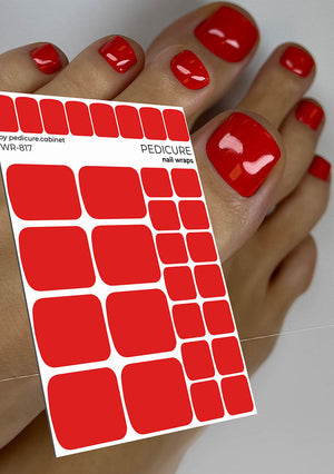 Red nail wraps with a sheet and a hand with red nails against a neutral background
