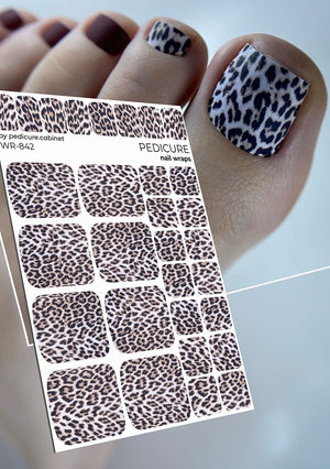 Leopard print nail wraps with a hand displaying similar design on nails against a neutral background
