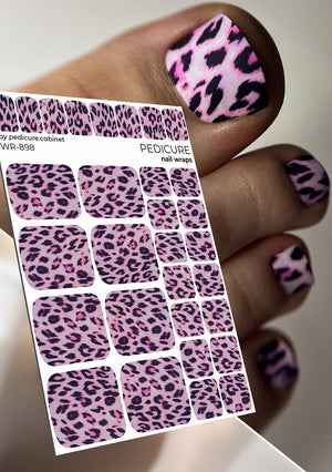 Pink and black leopard print nail wraps with a hand displaying similar designs.