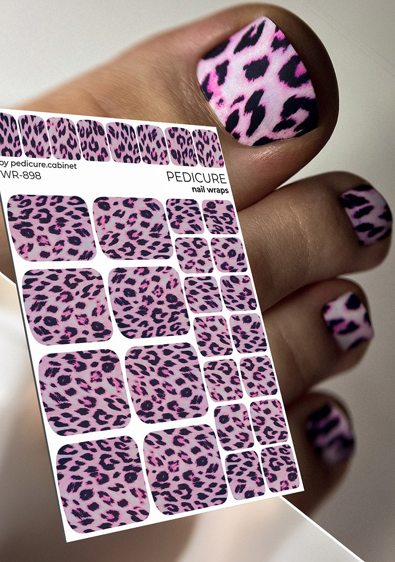 Pink and black leopard print nail wraps with a hand displaying similar designs.