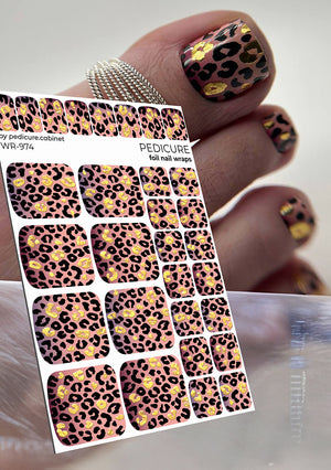 Leopard print nail wraps with a hand displaying similar designs.