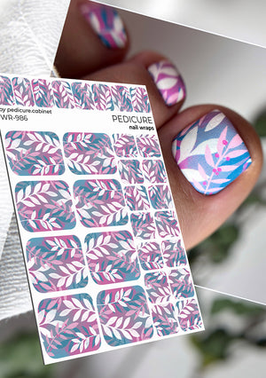 Nail wrap sheet with pink and blue leaf pattern and a hand with decorated nails.