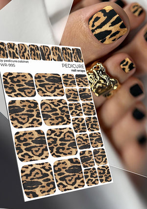 Leopard print nail wraps with a person wearing them on their nails.