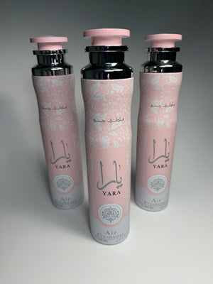 Three bottles of Lattafa Yara air freshener spray with pink decorative patterns on a white background.