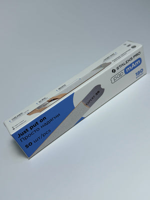 A pack of white disposable nail files with 180 grit, designed for nail care, displayed in its packaging.