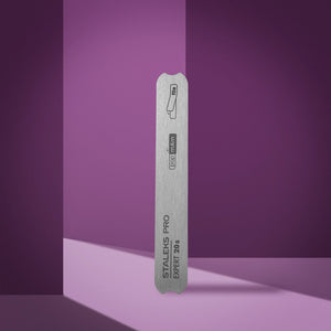 A straight metal nail file base with notches, branded as 'Staleks Pro', against a purple background.