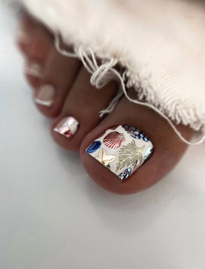 Close-up of toes with decorative nail art on a white background