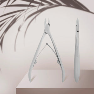 A pair of professional cuticle nippers with straight cutting edges, shortened handles, and a satin finish, displayed against a neutral background.