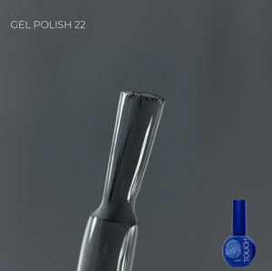 Nail art brush with a blue bottle labeled 'Touch' on a gray background