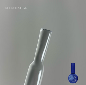 White nail file with a blue nail polish bottle labeled 'Touch' on a gray background