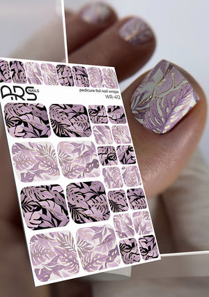 Nail art sticker sheet with leaf pattern and a hand with matching nails.